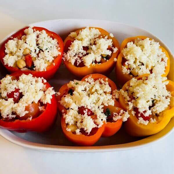 A dish of raw stuffed bell peppers.