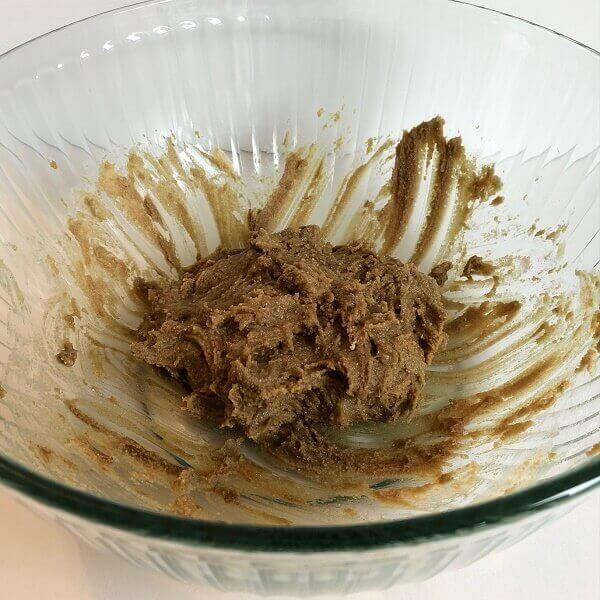 Cookie dough in large ribbed glass bowl.