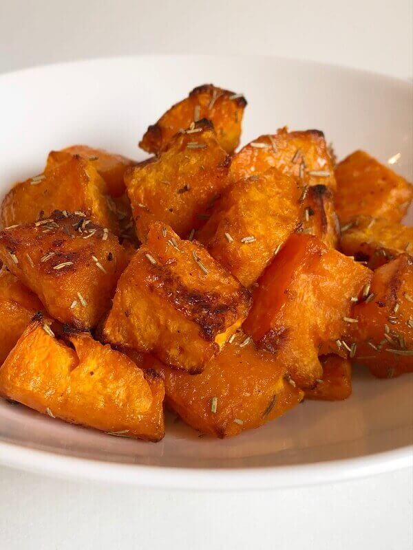 Roasted squash in a white bowl.