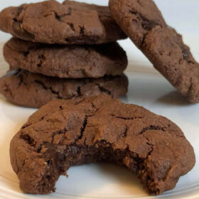 Cookies on a plate with a bite taken out of one.