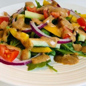 Colourful salad on a white plate.