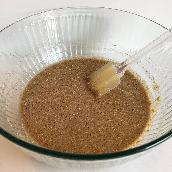 Cake batter in a bowl with a spatula.