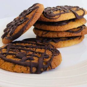 Six cookies stacked on a plate.