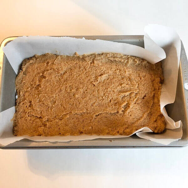 Banana cake batter in a loaf pan.