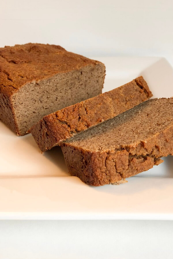 Banana loaf cake sliced on a plate.