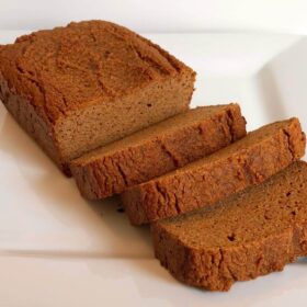 Carrot loaf cake with three slices cut.