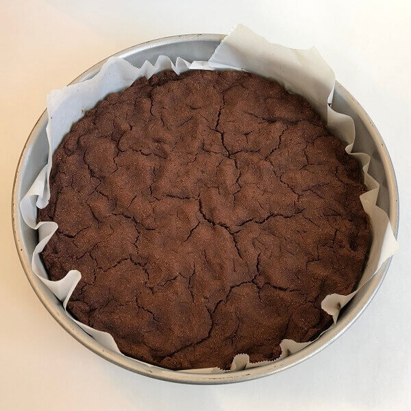 Baked bean cake in a round baking pan.