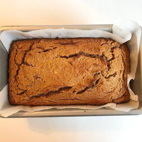 Freshly baked banana bread in a loaf pan.