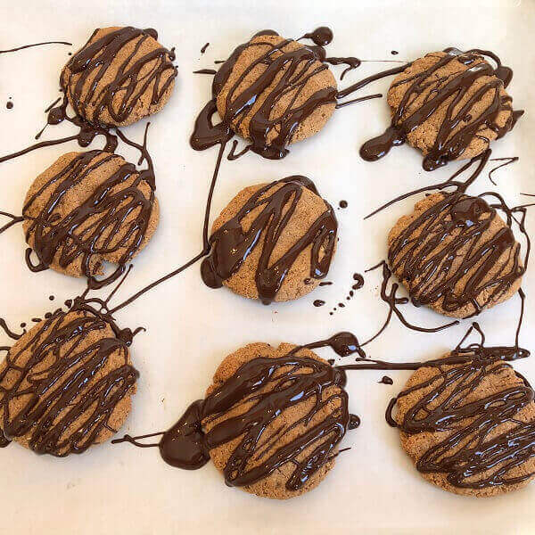 Cookies with melted chocolate drizzled on top.