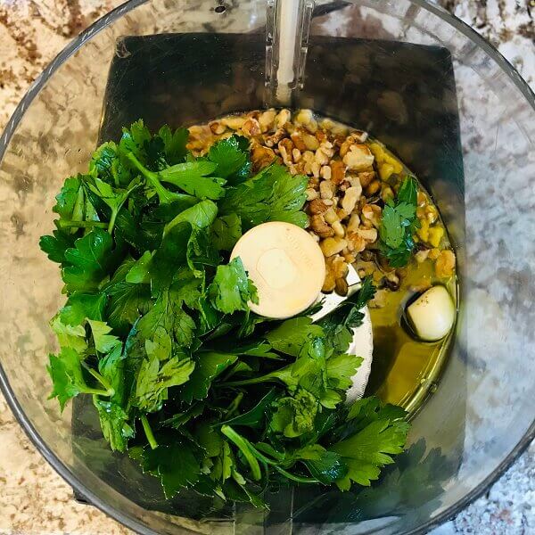 Ingredients for pesto in a food processor.