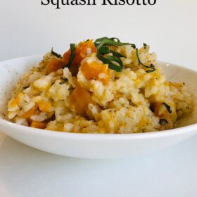 Risotto in a bowl with herbs sprinkled on top.