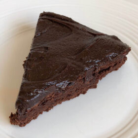 A slice of chocolate bean cake on a plate.