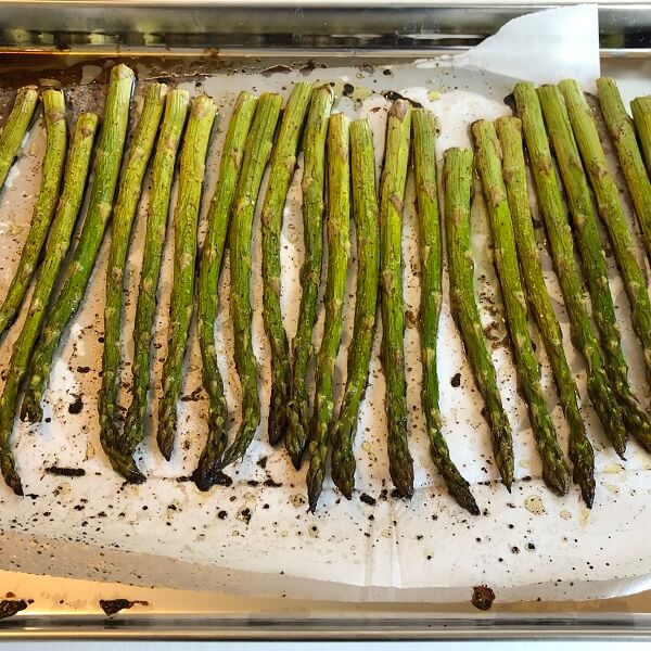 Cooked asparagus on a sheet pan.