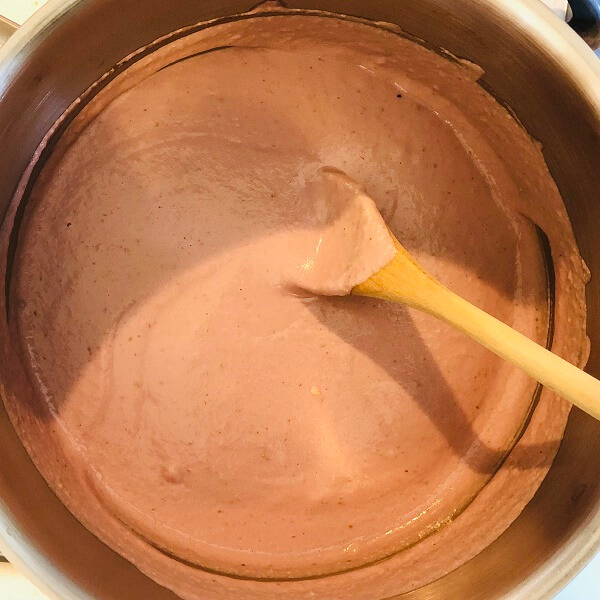 Thick pink liquid in a metal pot.