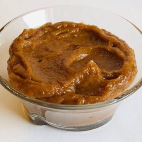 Pureed dates in a glass bowl.