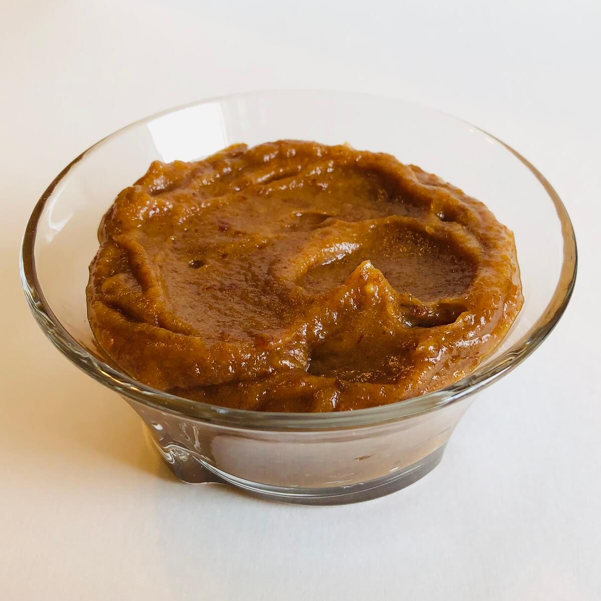 A paste made from dates in a glass dish.