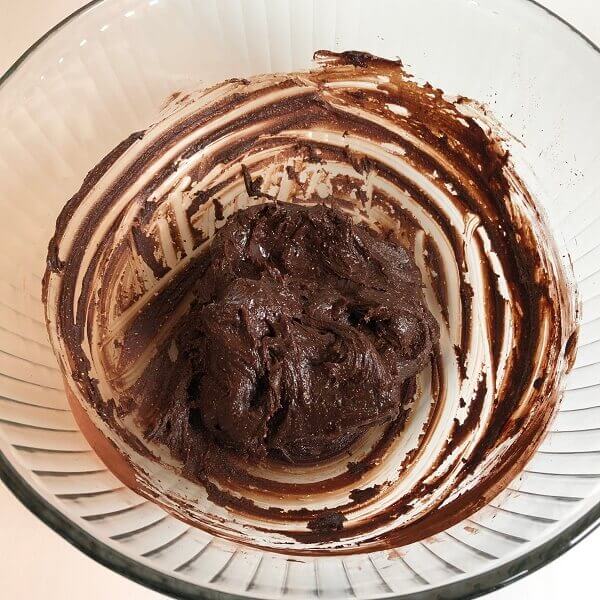 A ball of fudge dough in a glass bowl.