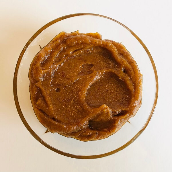 A glass dish filled with pureed dates.