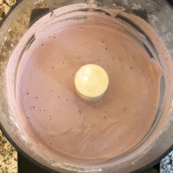 Pink liquid in a food processor.