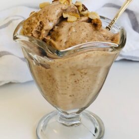 A glass dish filled with banana ice cream.