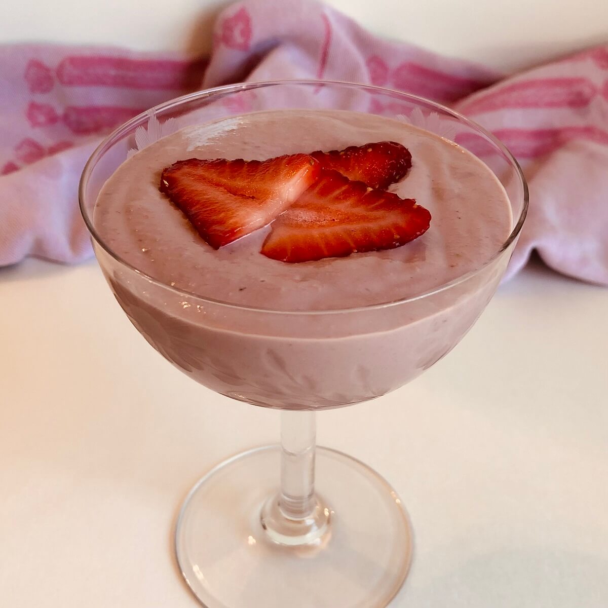 Vegan strawberry mousse in a glass dish.