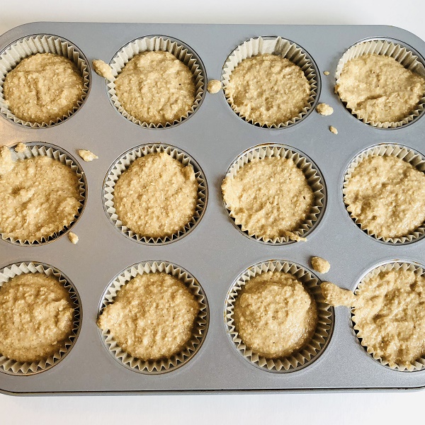 Raw muffins in a muffin pan.