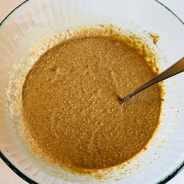 Thick muffin batter in a glass mixing bowl.