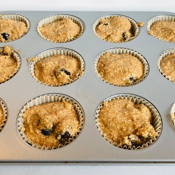 Raw muffins in a pan.