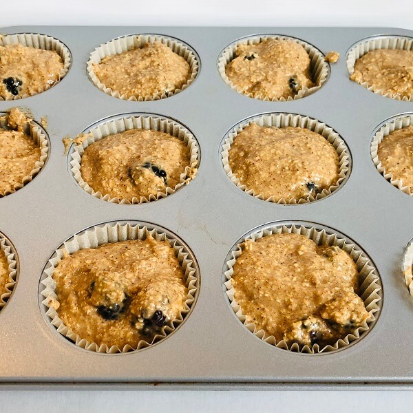 Raw muffins in a pan.