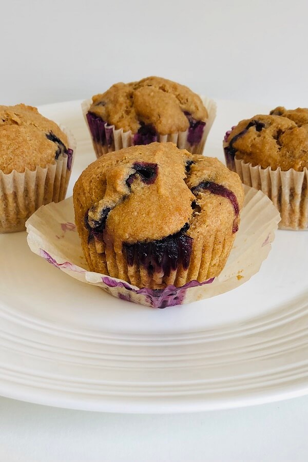 Blueberry muffins on a white plate.