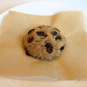 A vegan microwave cookie on a piece of parchment paper.