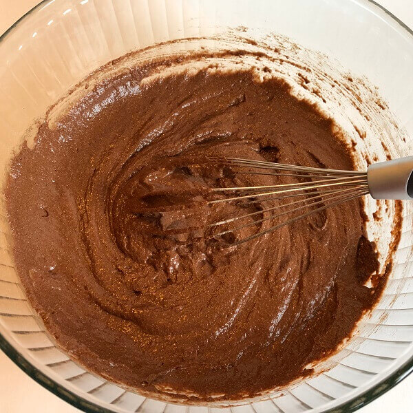 Cupcake batter in a glass mixing bowl.