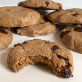 Cookies piled on a white plate.