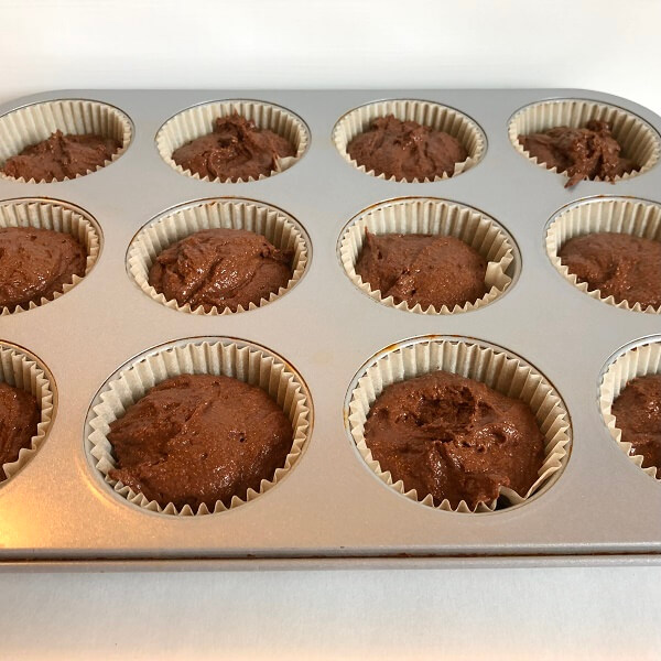 Raw cupcakes in a muffin pan.