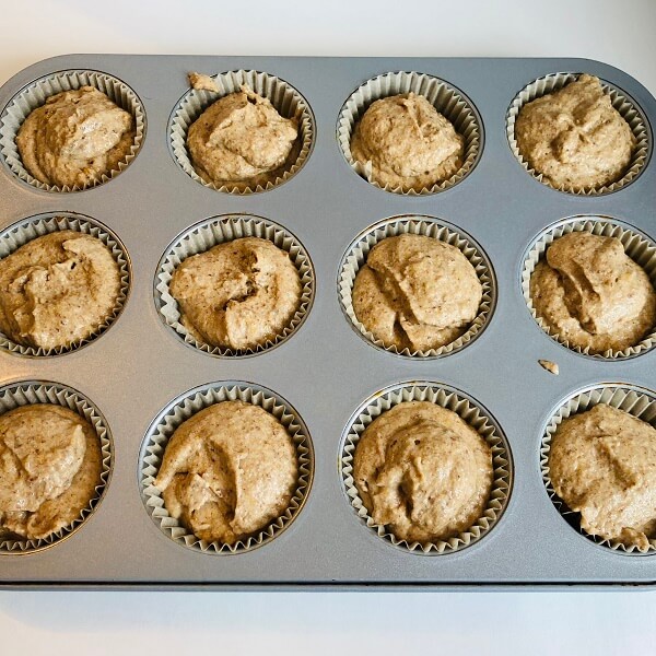 Raw flax muffins in a baking pan.