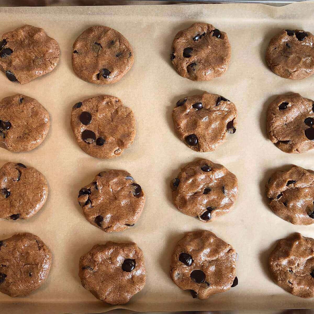 Raw maple chocolate cookies on a baking pan.