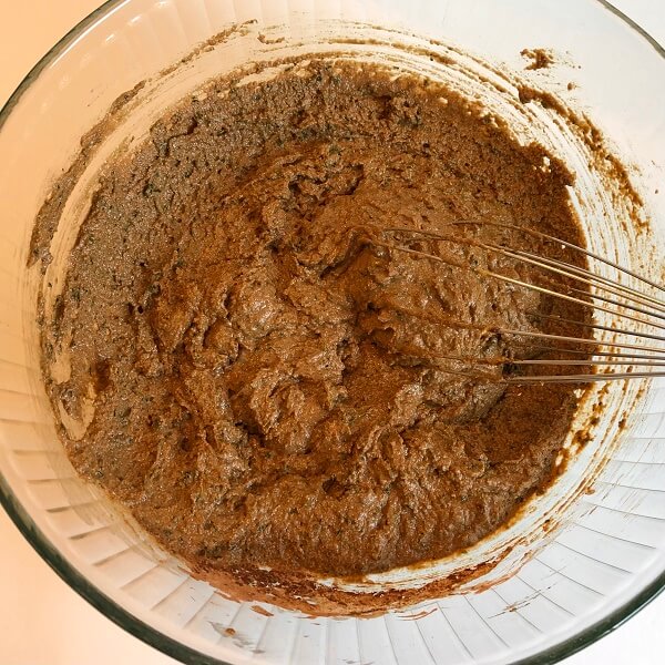 Vegetable muffin batter in a glass mixing bowl.