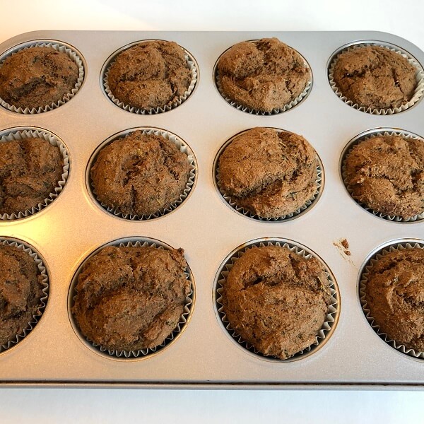 Freshly baked muffins in a metal pan.