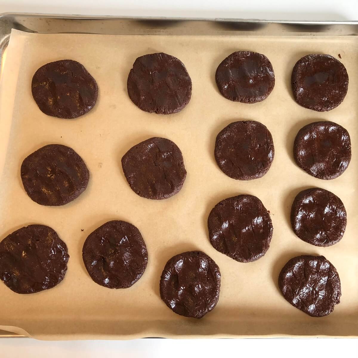 Raw spelt cookies on a sheet pan.
