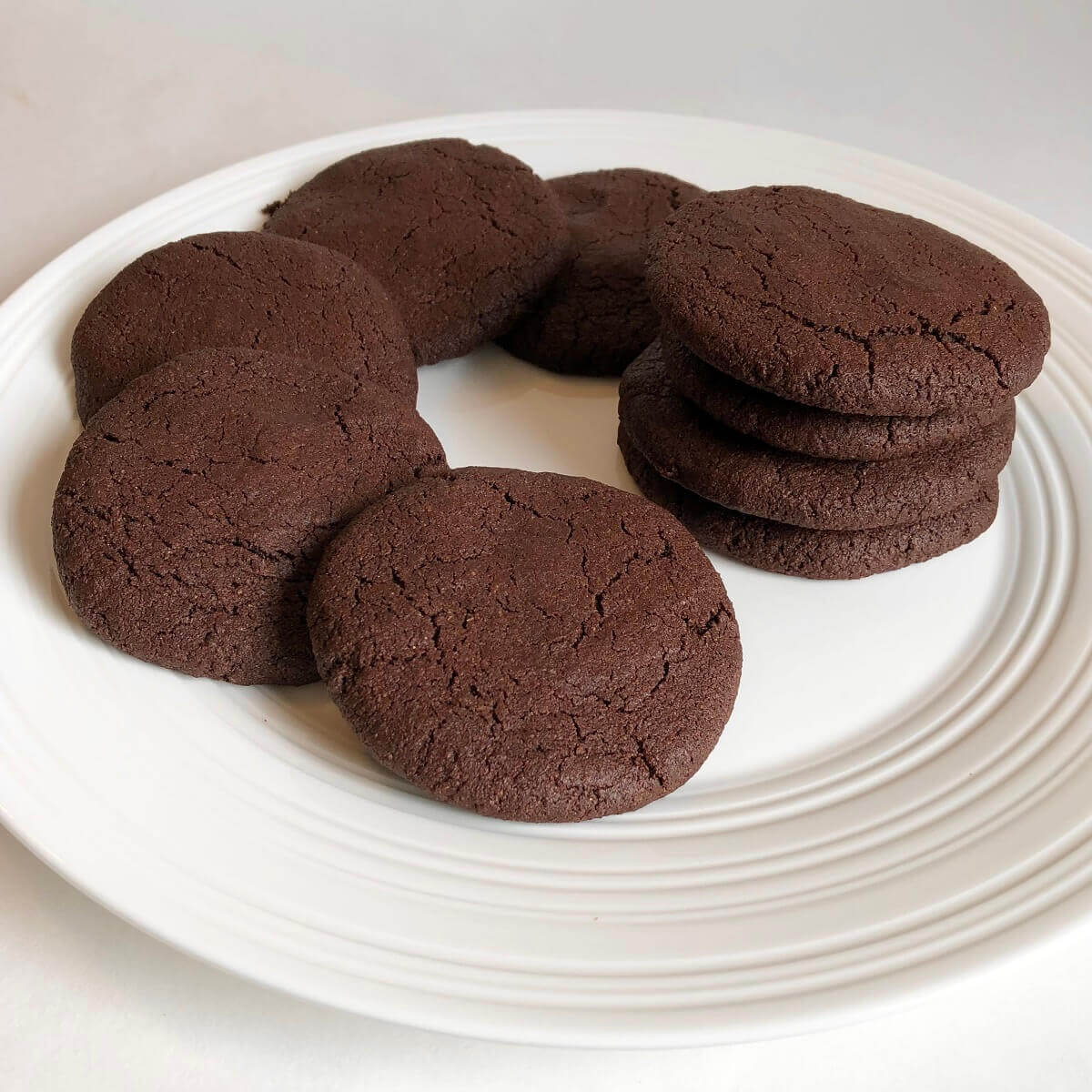 Nine cookies displayed on a white plate.