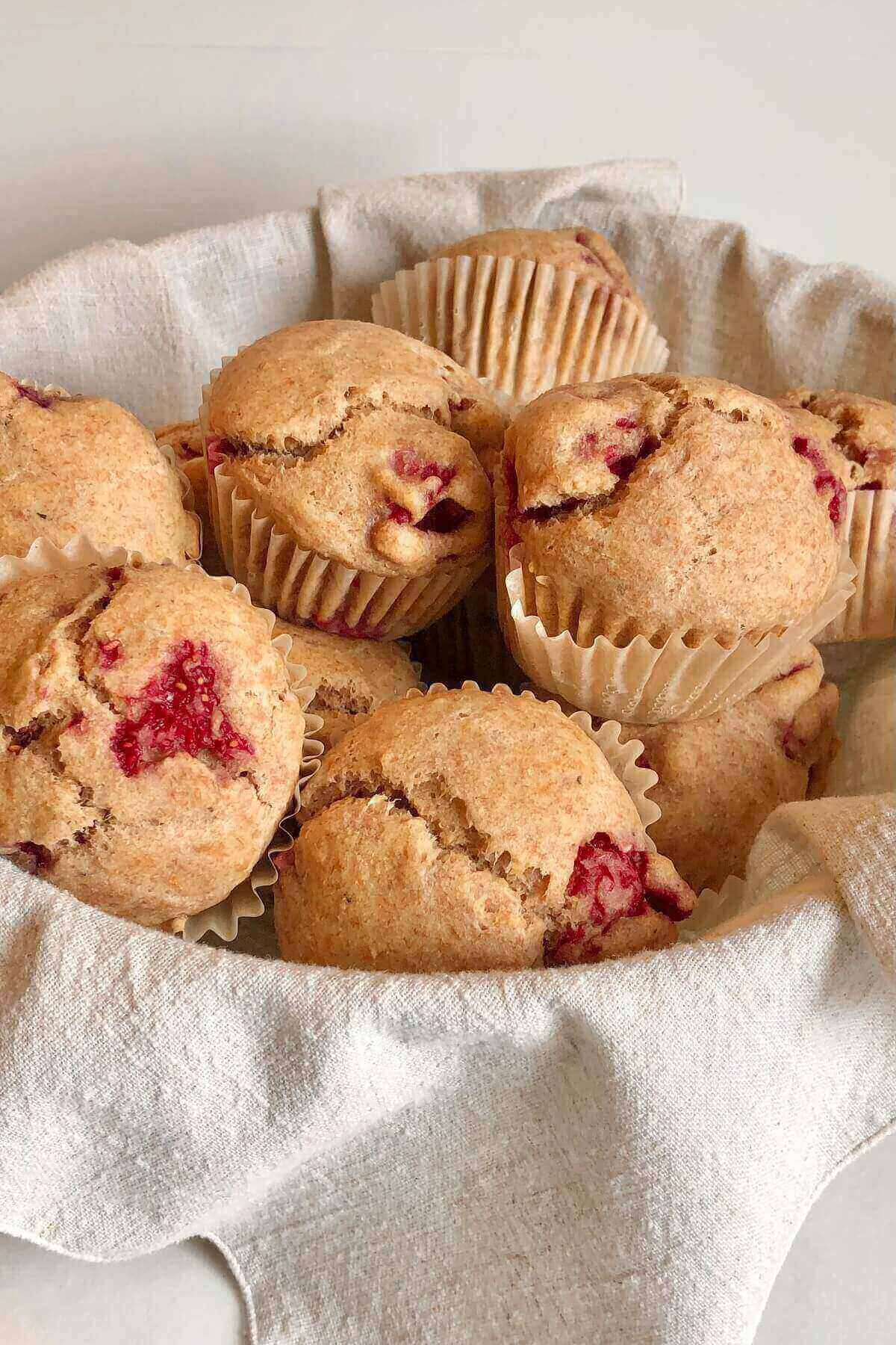A basket full of raspberry muffins.