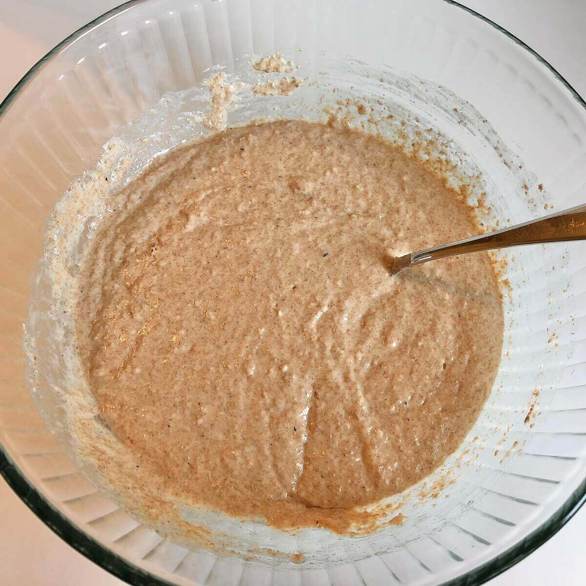 Vegan muffin batter in a large glass mixing bowl.