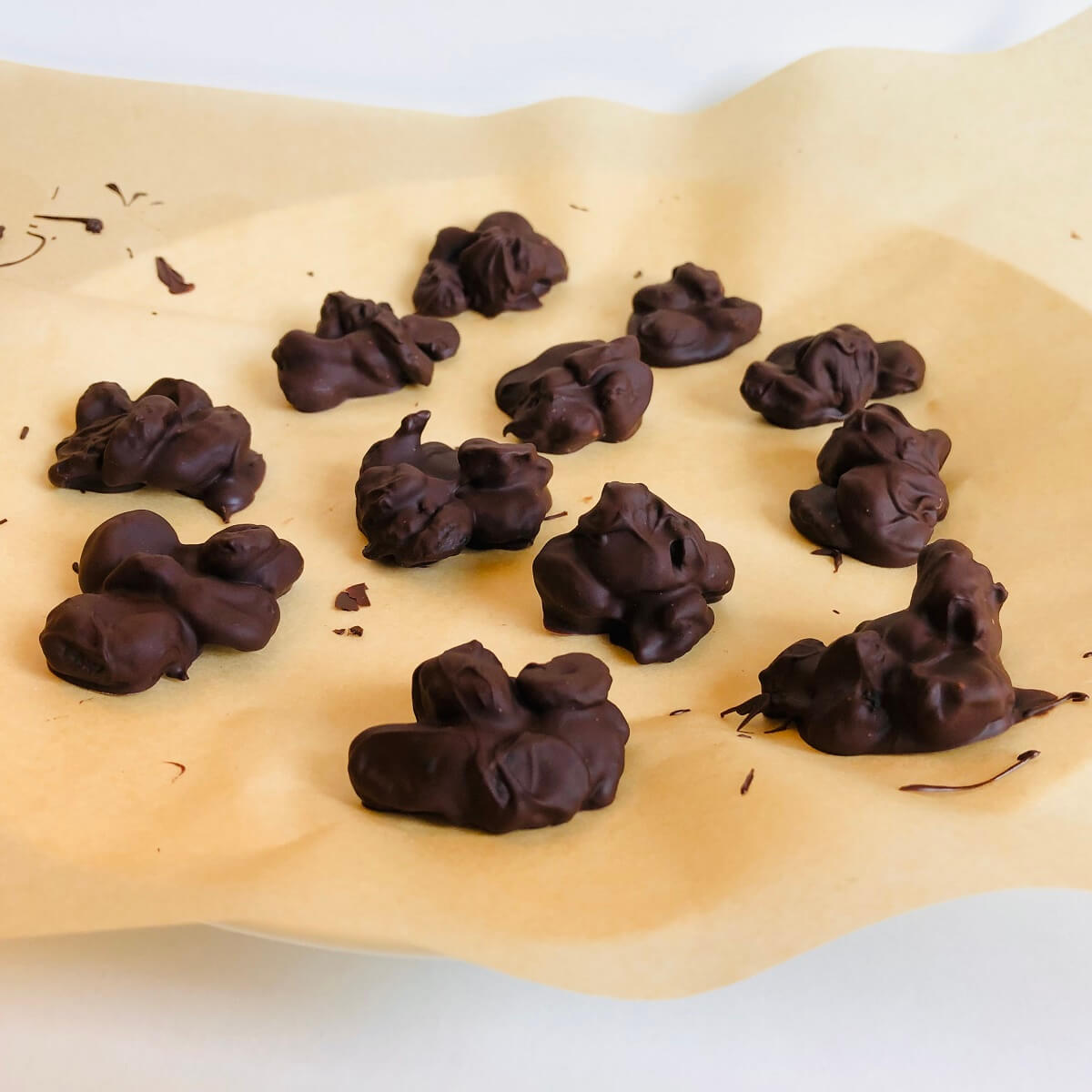 Chocolate cherries on a piece of parchment paper.