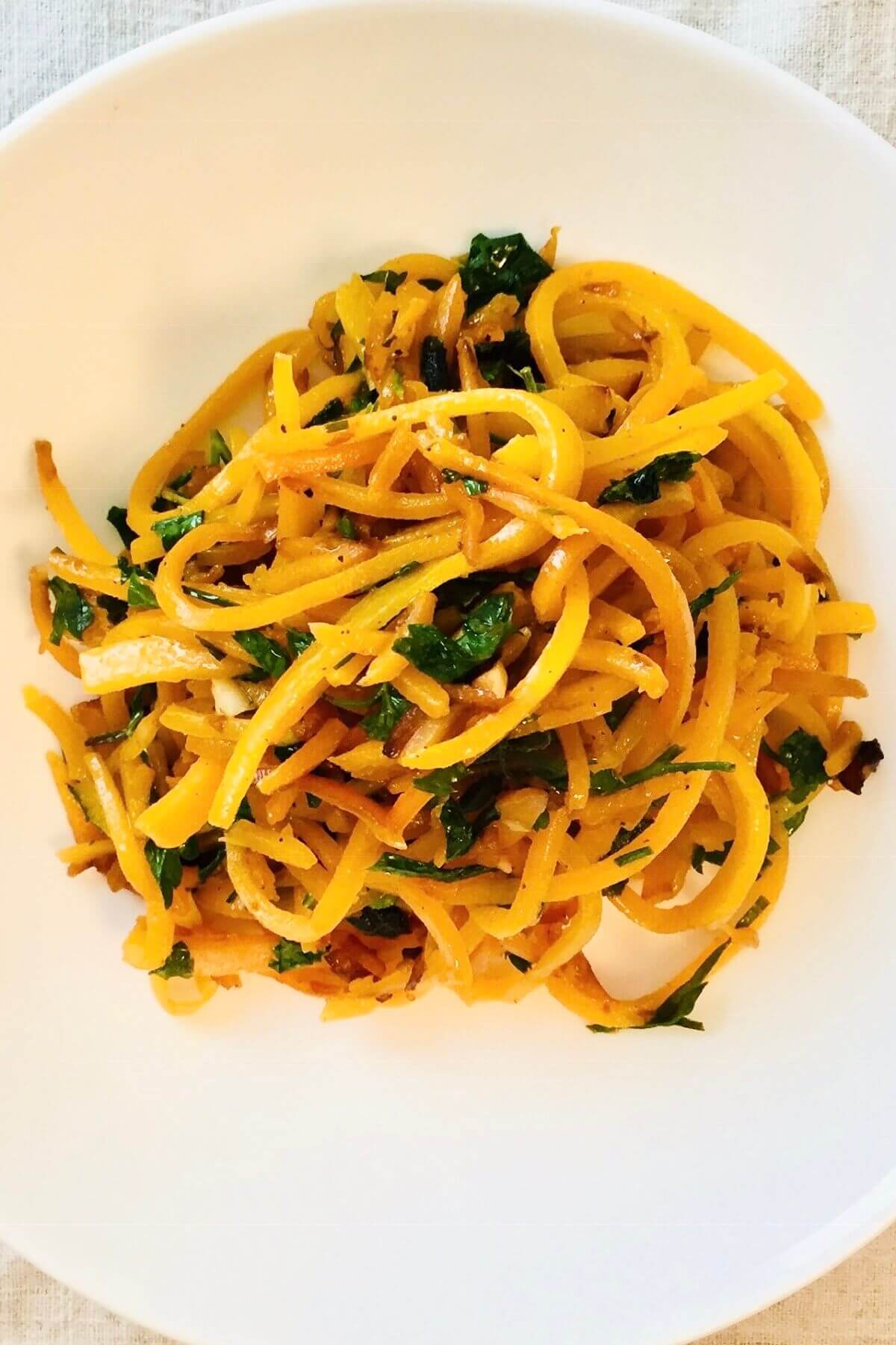 Butternut squash with herbs in a bowl.