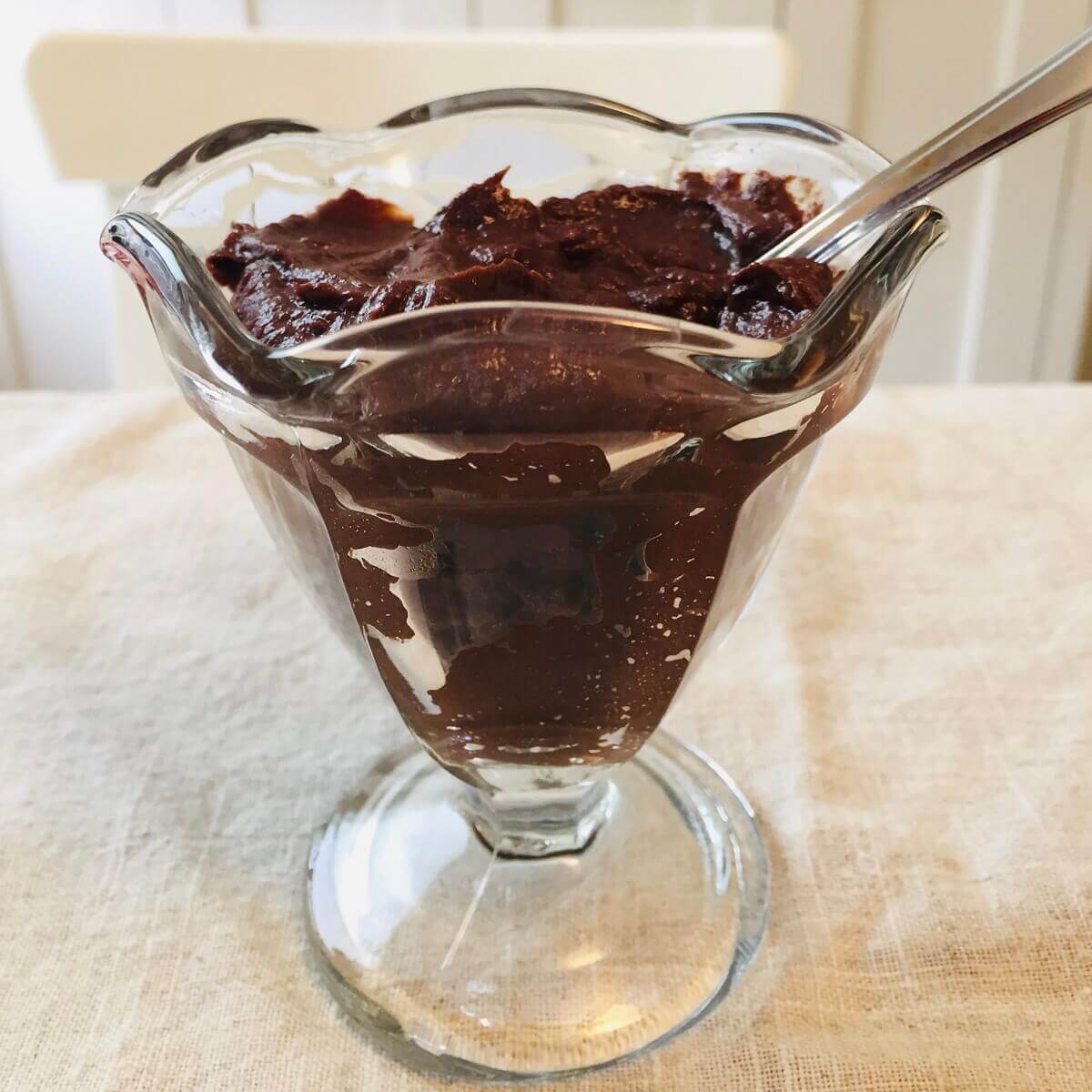 A glass dish filled with chocolate pudding.