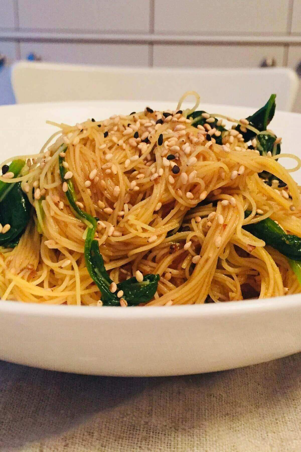 Noodles piled high in a white bowl.
