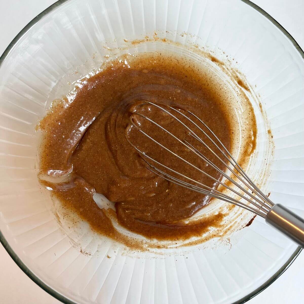 Wet ingredients in a large glass mixing bowl.