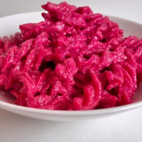 Pasta smothered in beet sauce.