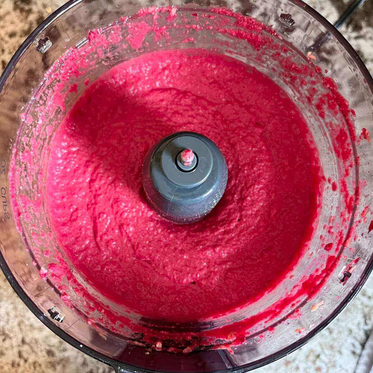 Pink sauce in a food processor.
