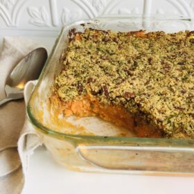 Sweet potato casserole without marshmallows in a square glass baking dish.
